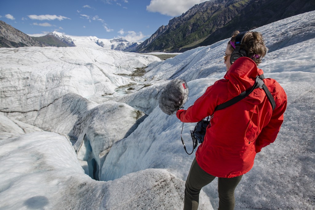 image of Jennifer Jerrett with recording equipment on a glacier