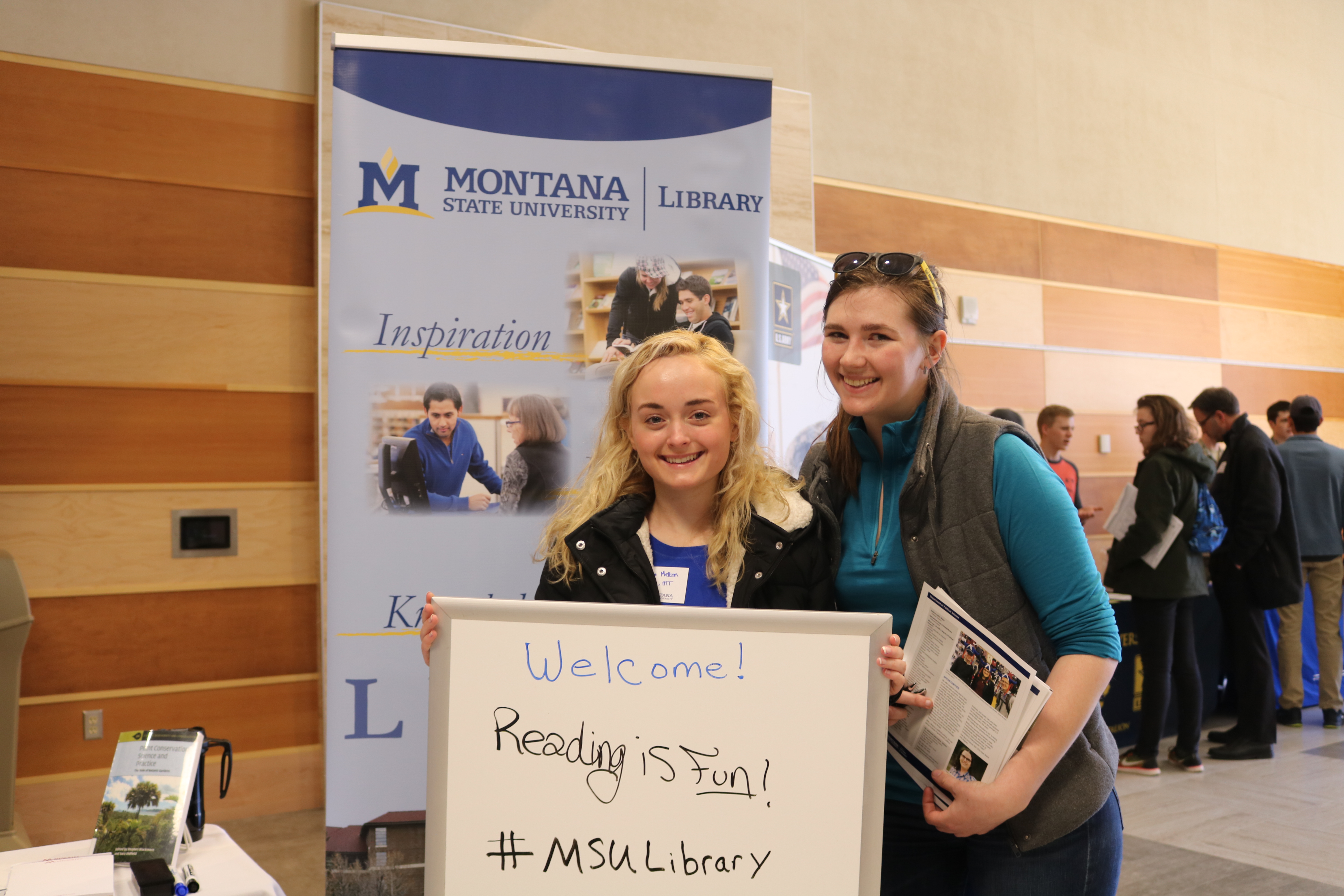 MSU students at a library event; two people smiling
