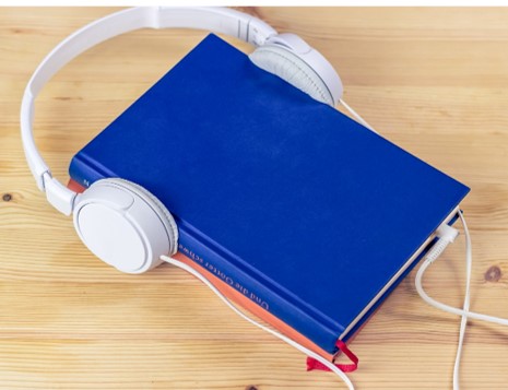 Blue book wearing white headphones