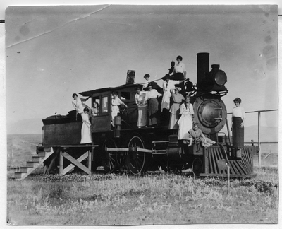 Women posing on college locomotive engine