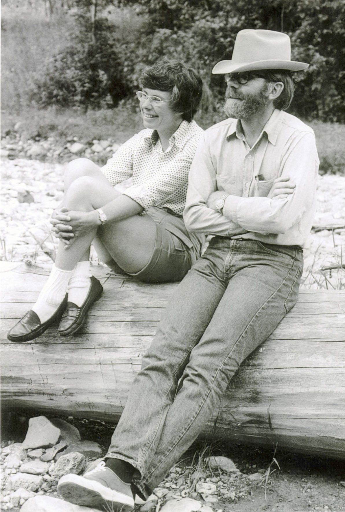 Carol and Ivan Doig sitting on a log in Montana in 1978