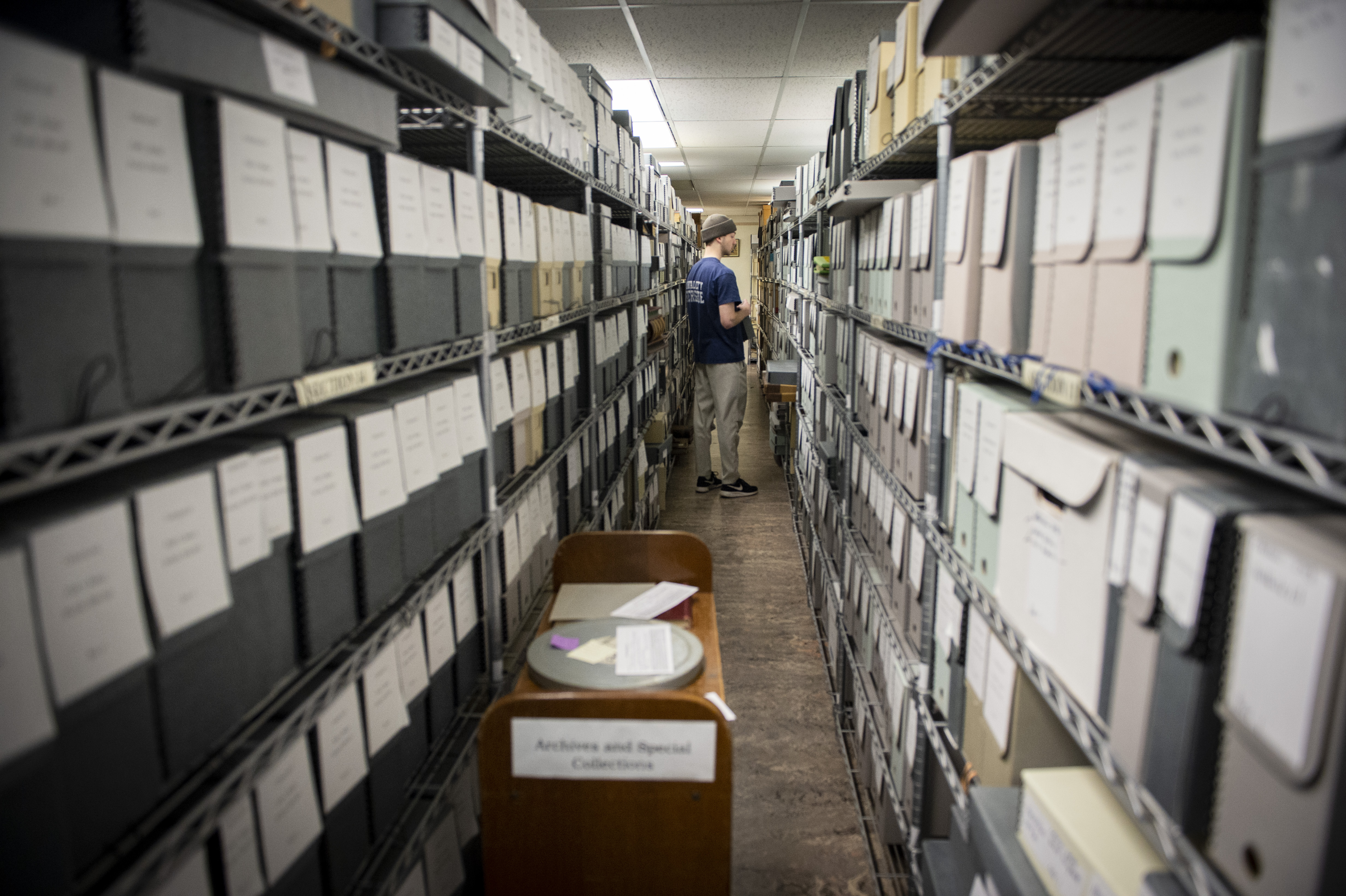 A student worker in the archives stacks