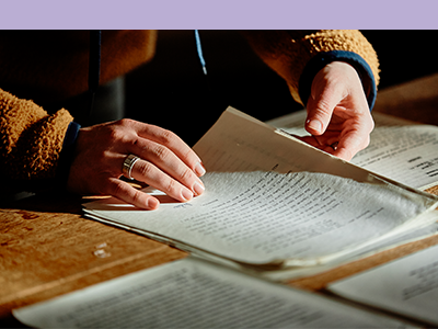 Researcher's hands and historical document Image of researcher's hands and historical document