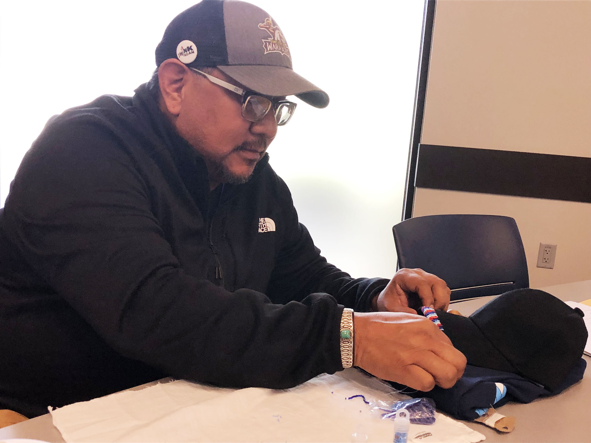 photo of tcli participant beading 